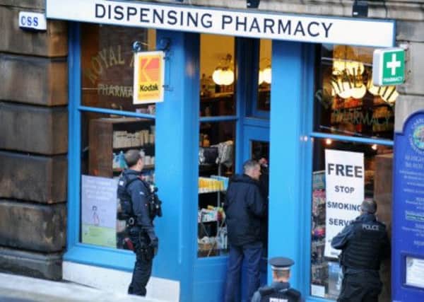 Police stand outside the Royal Mile Pharmacy in May this year. Picture: Jane Barlow