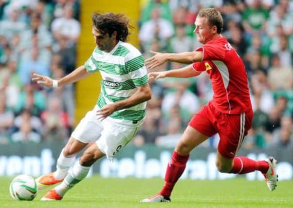 Georgios Samaras holds off Cliftonville's Ciaran Caldwell. Picture: PA