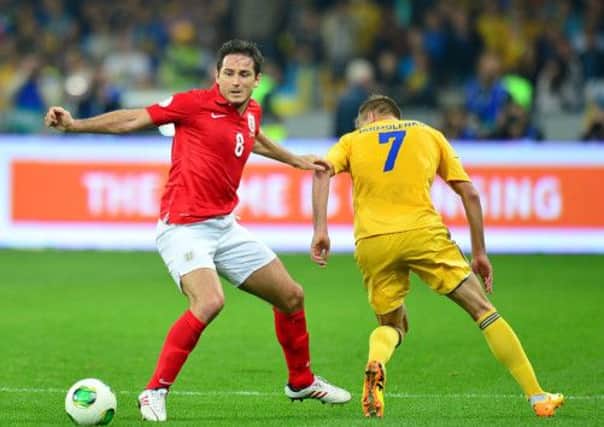 England's 100-cap man Frank Lampard battles Ukraine's Andriy Yarmolenko. Picture: PA