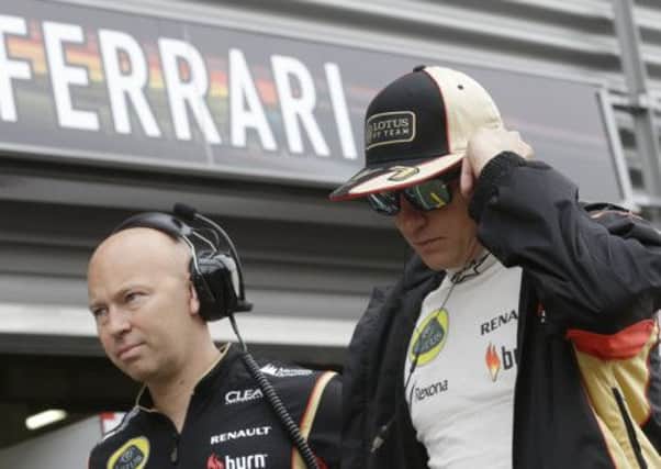 Lotus driver Kimi Raikkonen walks past the Ferrari pit at Spa, Belgium, earlier this year. Picture: AP