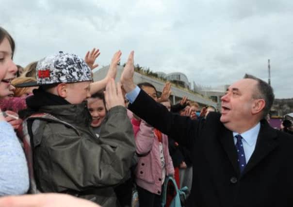 First Minister Alex Salmond gives out 'high 5s' to school children at the Scottish Parliament. Picture: Jane Barlow
