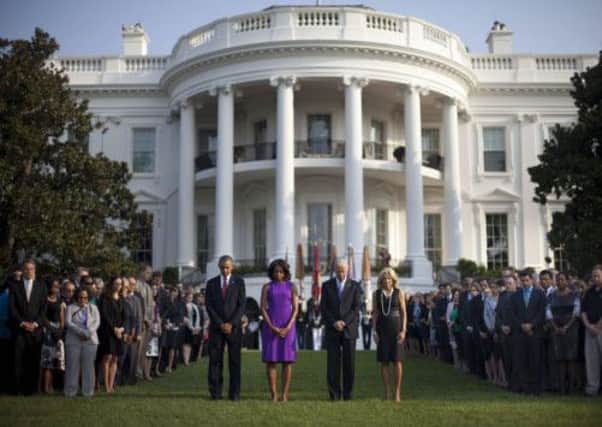 President Barack Obama, first lady Michelle Obama Vice President Joe Biden and Jill Biden lead a moment of silence to mark the 9/11 attacks. Picture: AP