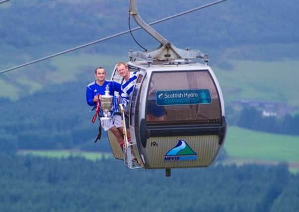 Robbie Macleod of Kyles, left, and Jamie Robinson of Newtonmore took to the Nevis Range to promote the 2013 Scottish Hydro Camanachd Cup final today. Picture: Jeff Holmes