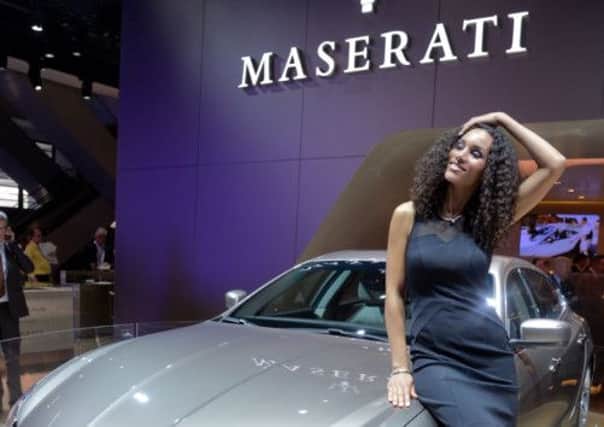 A model stands beside the Maserati Quattroporte Ermenegildo Zegna at the IAA International Automobile Exhibition in Frankfurt, Germany. Picture: Getty