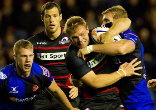 Edinburghs Greig Tonks receives some close attention from Matthew Pewtner at Murrayfield. Picture: SNS