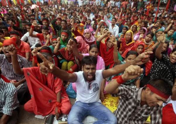 Bangladeshi garment workers protest for higher wages and compensation for victims of May's factory collapse. Picture: AP