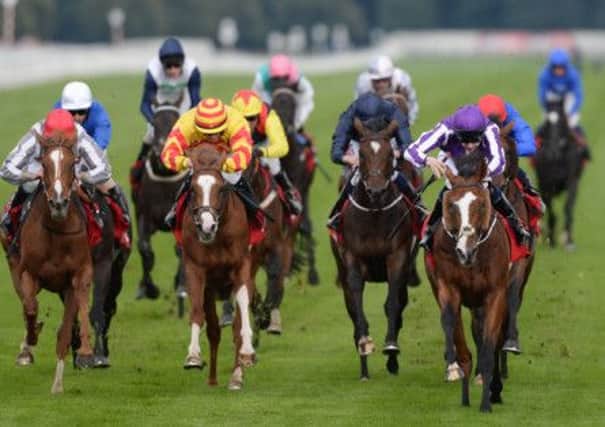 Follow the leader: Leading Light (right) wins the Ladbrokes St Leger Stakes at Doncaster yesterday afternoon. Picture: PA