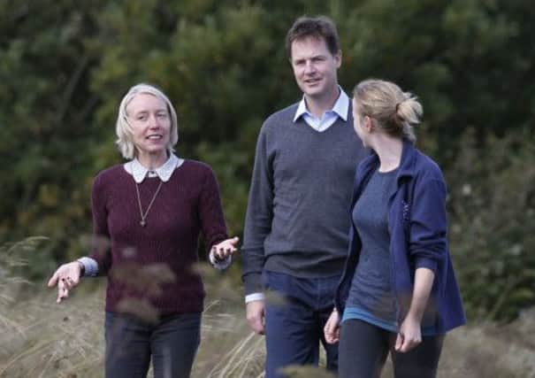 Before attending the conference, Clegg joins head of policy for the Scottish Wildlife Trust, Dr Maggie Keegan, left, and Cathkin Marsh Project officer Laura Cunningham, right, during a visit yesterday to the reserve. Photograph: Danny Lawson