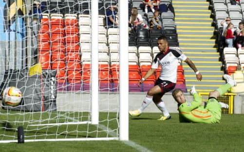 Aberdeen's John Magennis takes the ball past the keeper. Picture: SNS