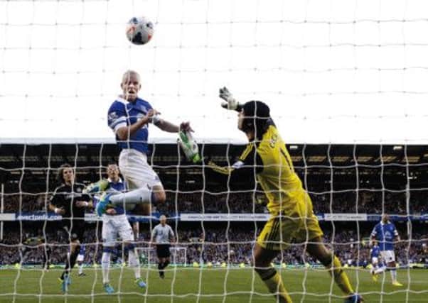 Flying Scotsman: Steven Naismith belies his modest stature to rise and head home Nikica Jelavics header. Photograph: PA