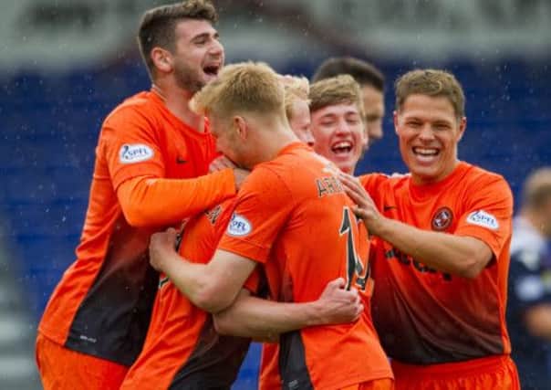 Dundee United players celebrate their opening goal. Picture: PA
