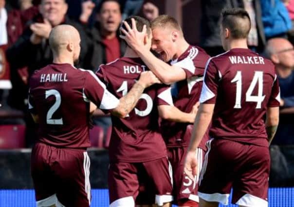 Jamie Holt celebrates his goal against Celtic with his team-mates - but the Tynecastle club's fate lies with others. Picture: SNS