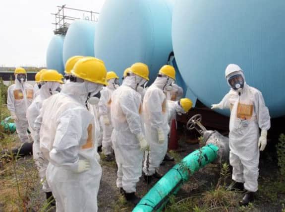 A team of experts check contamination levels at the stricken Fukushima plant. Picture: AP