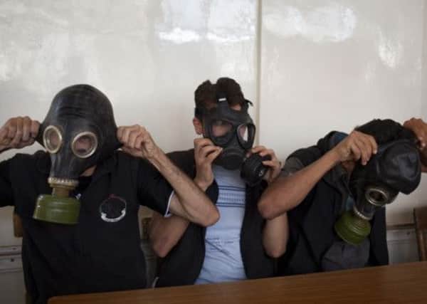 Volunteers in Aleppo wear protective gear during a class on how to respond to a chemical attack. Picture: Getty