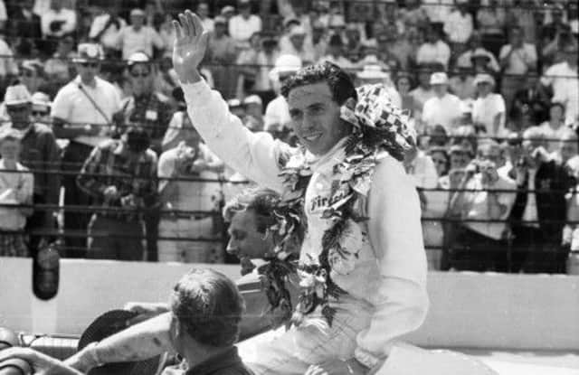 Jim Clark acknowledges the crowd after winning the coveted Indianapolis 500 in 1965. Picture: Getty