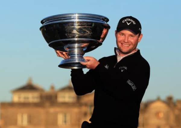 Branden Grace holds the trophy aloft after his victory in The 2012 Alfred Dunhill Links Championship. Picture: Getty