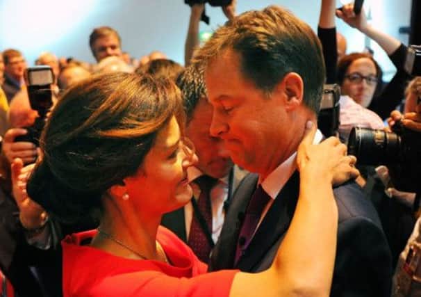 Nick Clegg is embraced by wife Miriam before he delivered the closing speech. Picture: Robert Perry