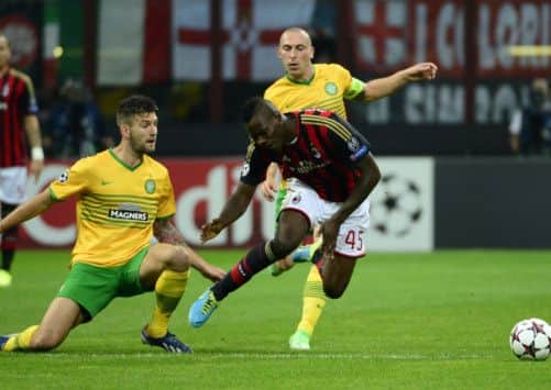 Mario Balotelli (R) fights for the ball with Charlie Mulgrew. Picture: AFP
