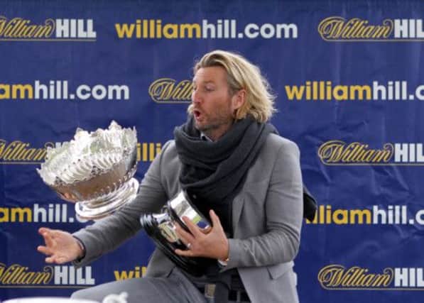 Robbie Savage almost dropped the Kilkerran Cup as he got ready to make the presentation at Ayr Racecourse. Picture: PA