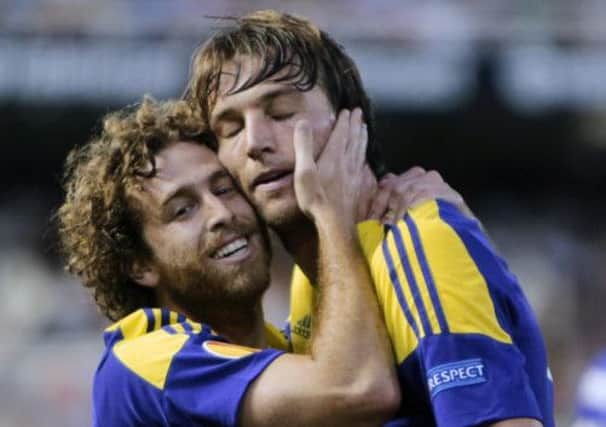 Michu, right, is congratulated by Spanish compatriot Jose Canas after putting Swansea 2-0 up. Picture: AP