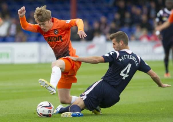 Ball winner: Dundee United starlet Ryan Gauld goes into a challenge with Ross Countys Stuart Kettlewell. Picture: Bill Murray/SNS