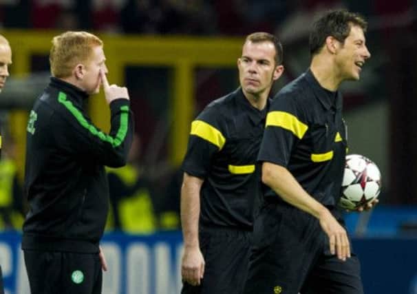 The match officials in the San Siro appear unimpressed by Neil Lennons line of questioning at full-time. Picture: SNS