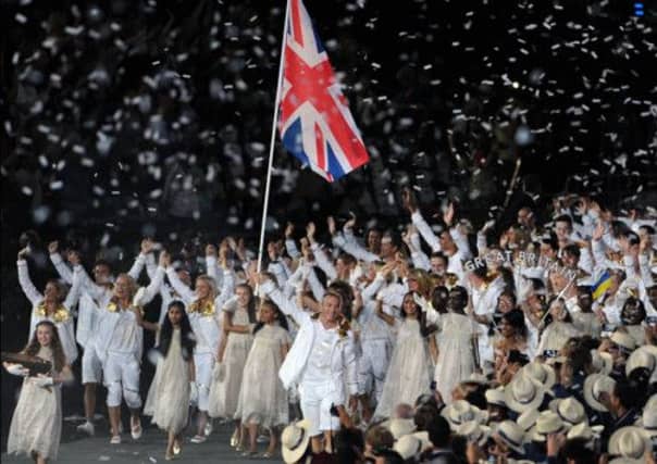 Sir Chris Hoy carries the flag at the London 2012 opening ceremony. Picture: Ian Rutherford