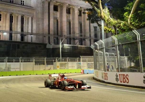 Ferraris Fernando Alonso negotiates a corner during yesterdays first practice session for the Singapore Grand Prix. Picture: AFP/Getty