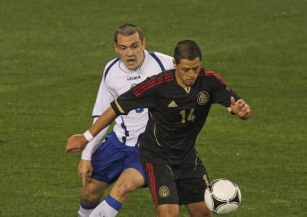 Boris Pandza (in white) takes on Manchester United's Javier Hernandez in a game between Bosnia and Mexico. Picture: Getty
