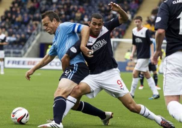 Phil Roberts, right, puts in a determined challenge on Dundee skipper Gavin Rae. Picture: SNS