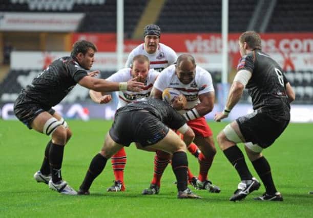 Edinburgh Rugby's Aleki Lutui is tackled by Ospreys' Duncan Jones. Picture: CameraSport/Ian Cook