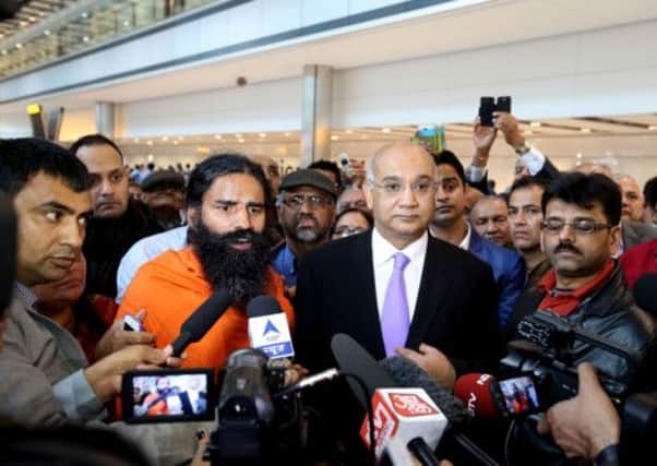 Yoga Guru Swami Ramdevji, with Keith Vaz at Heathrow Airport, was due to travel on to Little Cumbrae. Picture: PA