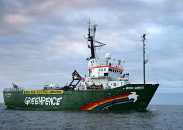 Around 30 activists including six Britons remain under armed guard after the Arctic Sunrise was boarded by Russian officials. Picture: AFP