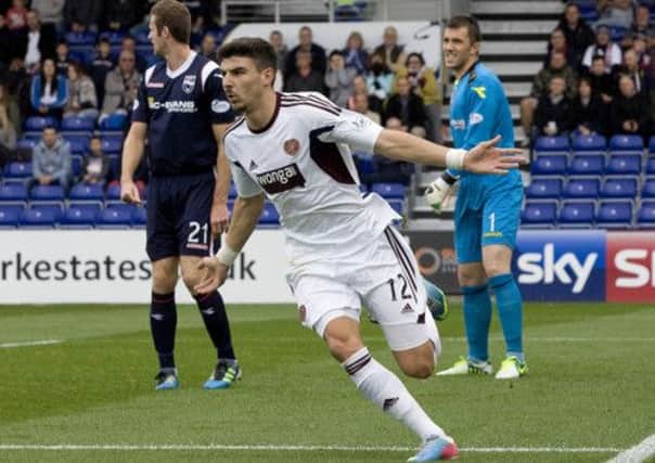Callum Paterson opened the scoring in Dingwall yesterday but a late double robbed Hearts of victory. Picture: SNS