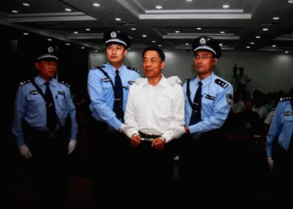 A handcuffed Bo Xilai is led from the Jinan court that sentenced him to life imprisonment yesterday. Picture: Getty Images