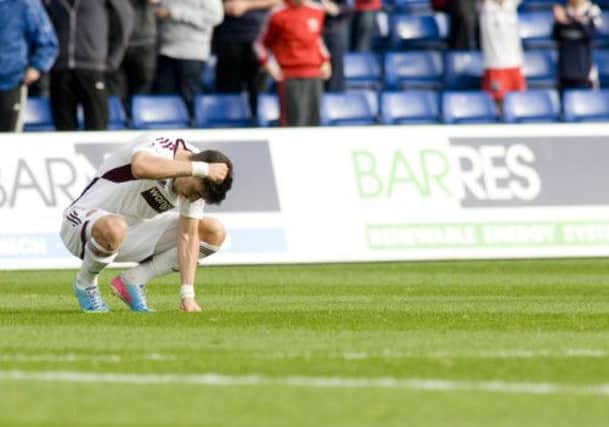 Hearts goalscorer Callum Paterson shows his dejection after two strikes by Ross County in the dying moments. Picture: SNS