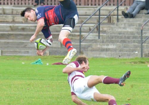 Watsonians Rory Steele, bottom, sends Dundee HSFP tryscorer Bryce Hosie flying. Picture: Jon Savage