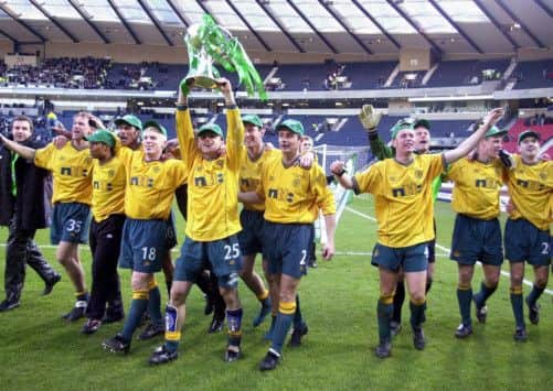 Neil Lennon joins in the celebrations of Celtics League Cup win in 2001  the last time they won a treble. Picture: PA