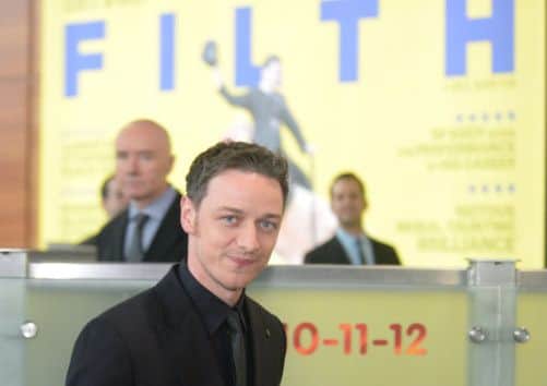 James McAvoy, with Irvine Welsh in the background, in Edinburgh today for the world premiere of Filth. Picture: Phil Wilkinson