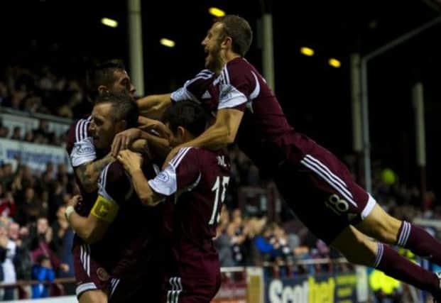 Hearts captain Danny Wilson celebrates his goal in extra-time with his team-mates. Picture: SNS