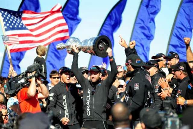Sir Ben Ainslie with the Americas Cup after Oracle Team USA won a finalrace showdown. Picture: Getty