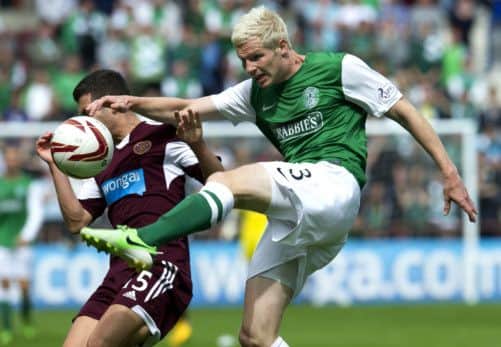 Hibs Ryan McGivern, right, and Jason Holt clash in the first derby of the season at Tynecastle. Picture: SNS