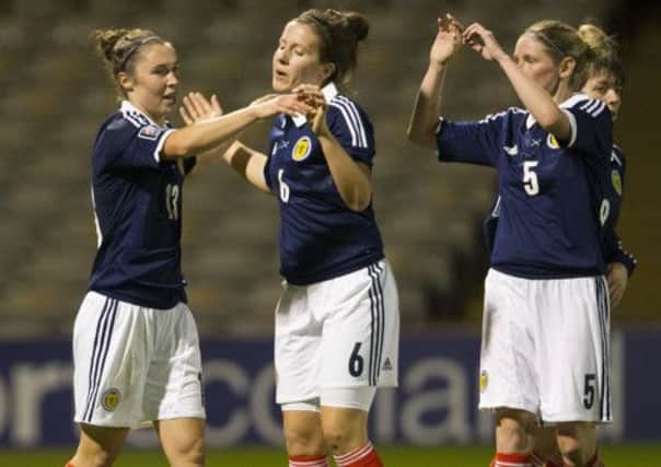 Jane Ross (left) is congratulated by Leanne Crichton (centre) and Leanne Ross after making it 5-0. Picture: SNS