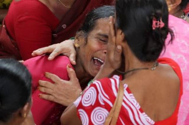 A woman cries yesterday for a missing relative at the site of the Mumbai building collapse. Picture: AP