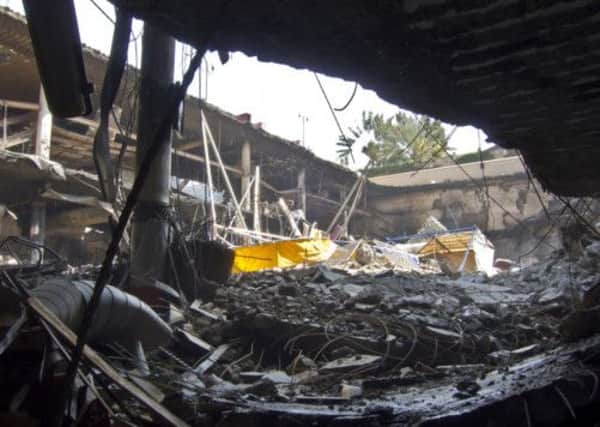 Rubble from the collapsed upper car park level covers buried vehicles at the Westgate Mall in Nairobi. Picture: AP