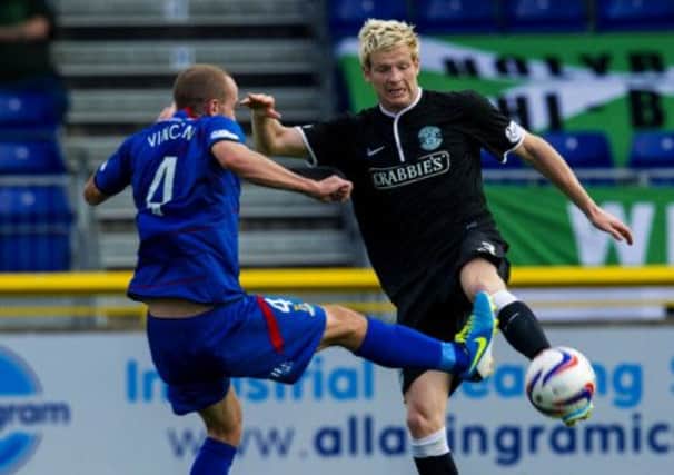 Hibernian's Ryan McGivern faces a challenge from James Vincent. Picture: SNS