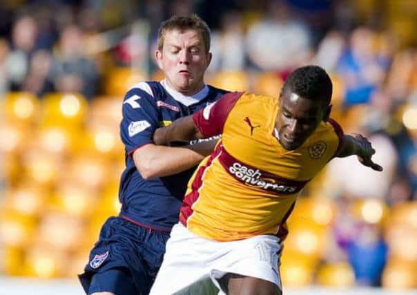 Ross County's richard Brittain puts pressure on Zaine Francis-Angol (right). Picture: SNS
