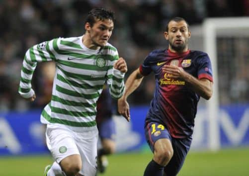 Tony Watt runs past Javier Mascherano in last year's famous Champions League clash. Picture: Robert Perry