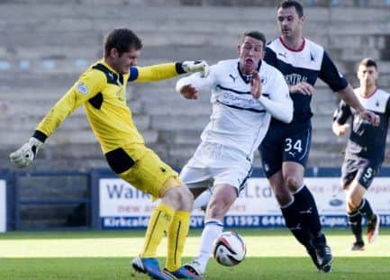 Raiths Calum Elliot is crowded out by Falkirks Michael McGovern, left, and David McCracken. Picture: SNS