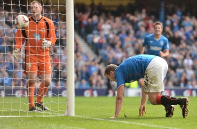 Rangers hitman Jon Daly rises from the turf to celebrate his third goal against Stenhousemuir at Ibrox on Saturday. Picture: SNS